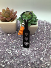 Load image into Gallery viewer, BDSM Heart Paddle Keyring, Black Acrylic w/Orange Tassel
